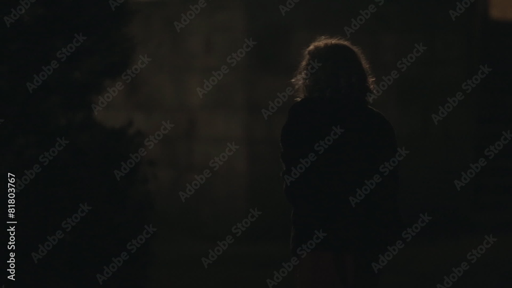 Frightened girl in the park at night, street light goes out Frightened girl in the park at night, street light goes out