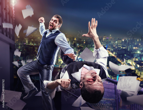 Businessmen fighting photo