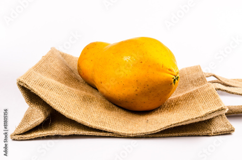 fresh yellow papaya with sack bag isolated on white background photo