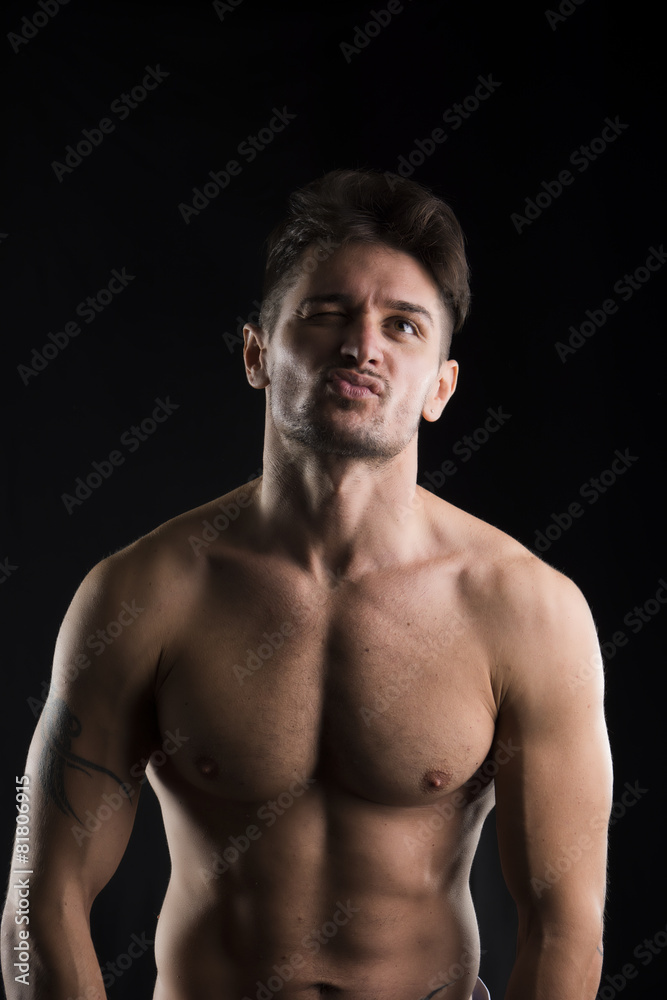 Fototapeta premium Handsome muscular, shirtless man looking up