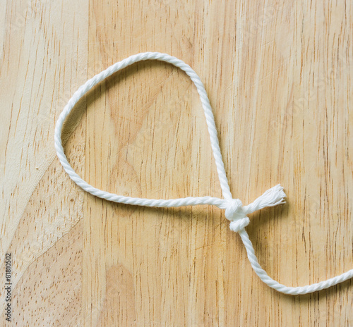 Frame composed of Rope on a Wooden background