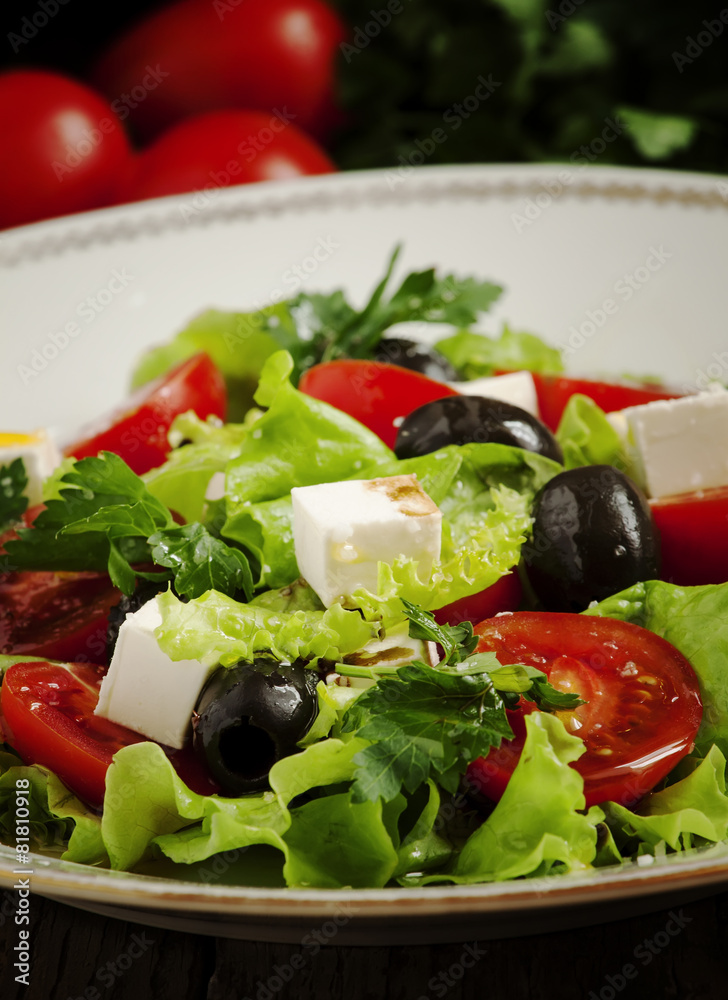 salad with tomatoes, olives and cheese, selective focus