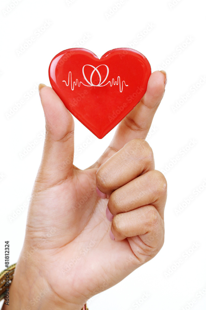 Red heart shape in woman's hand isolated on white background Red heart shape in woman's hand isolated on white background