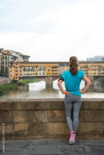 Fitness woman looking on ponte vecchio in florence, italy © Alliance