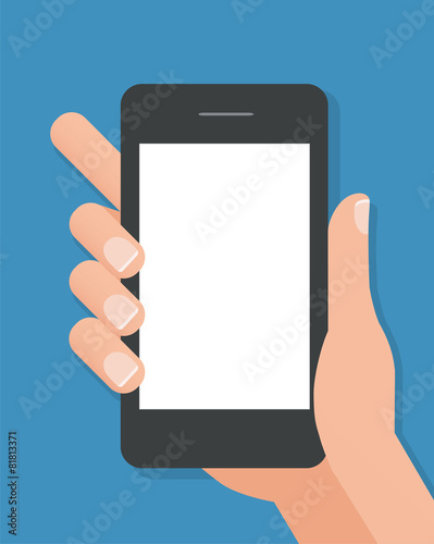 Hand holding black smart phone on blue background.