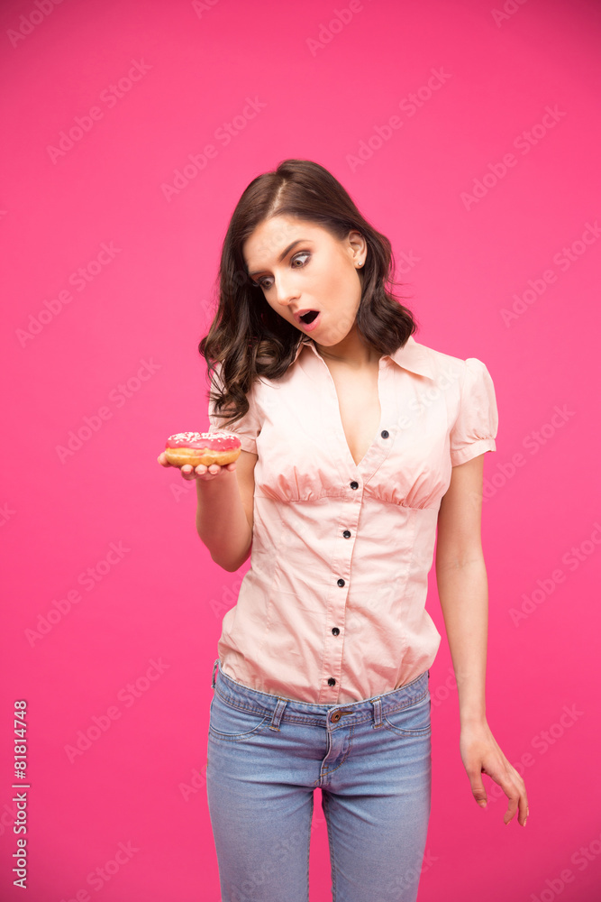 Surprised woman holding donut Surprised woman holding donut