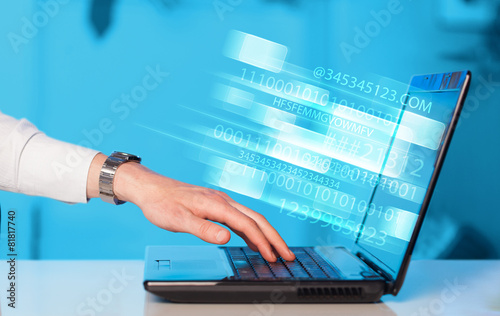 Close up of man typing on laptop computer