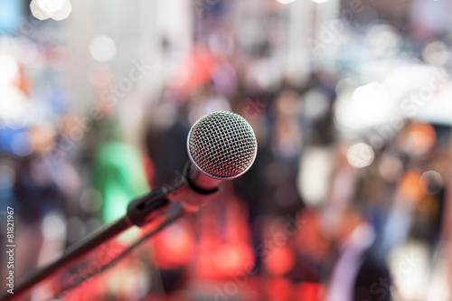 Microphone in focus against blurred audience photo