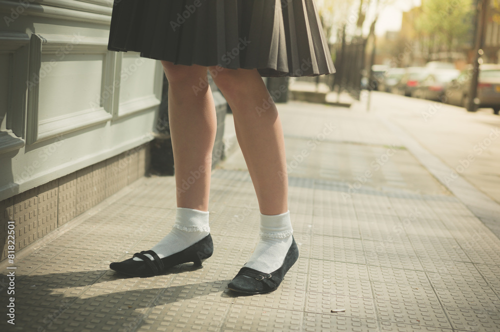 Woman in skirt walking the street