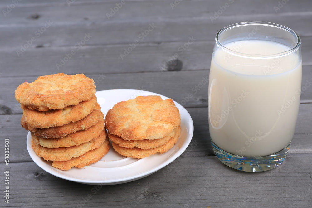 Glass of milk and cookies isolated on wood table Glass of milk and cookies isolated on wood table