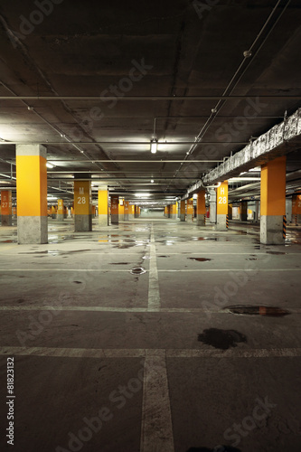 Image of parking garage underground interior, dark industrial bu