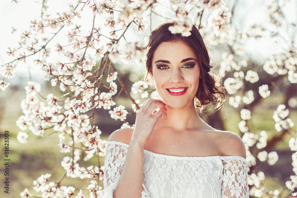 Portrait of young woman in the flowered garden in the spring tim Portrait of young woman in the flowered garden in the spring tim