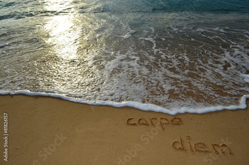 Sand writing 'carpe diem'