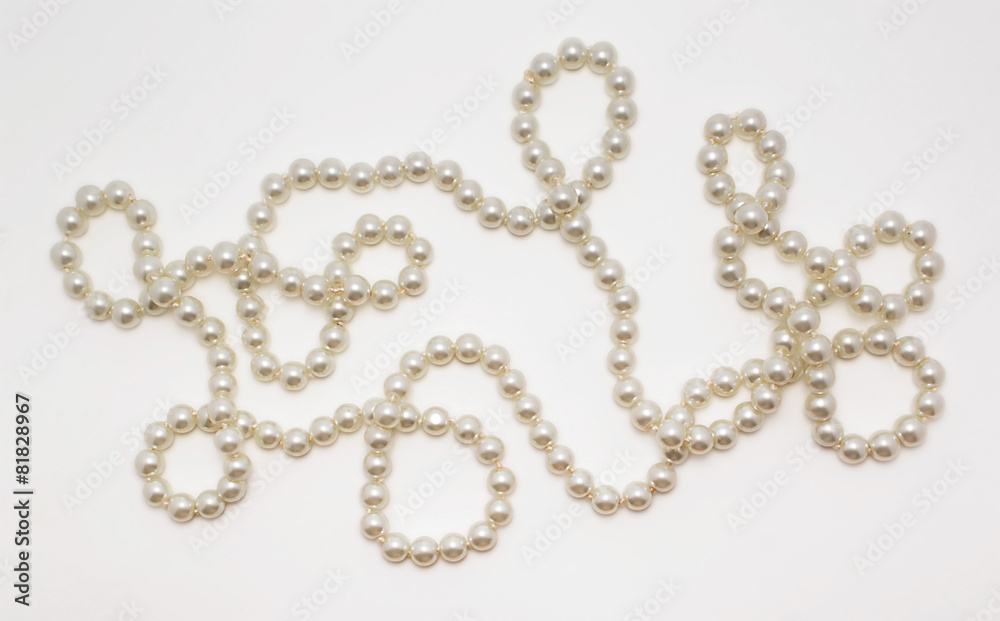 Beautiful necklace made of pearls on white background