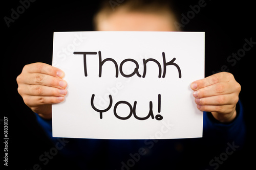 Child holding Thank You sign