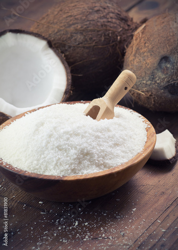 close up of a coconut and grounded coconut flakes