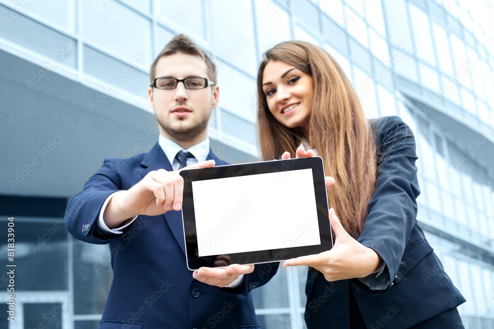 Successful young business people are holding a tablet, standing Successful young business people are holding a tablet, standing
