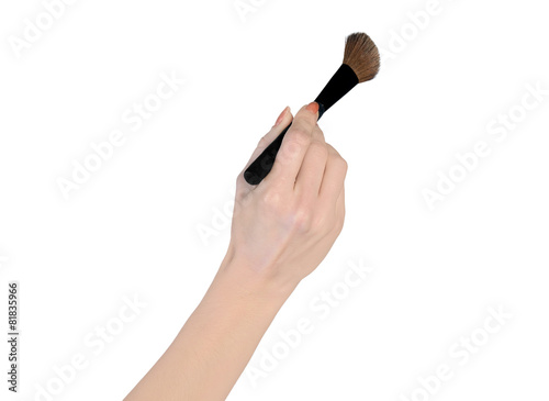 Woman hand holding makeup brush