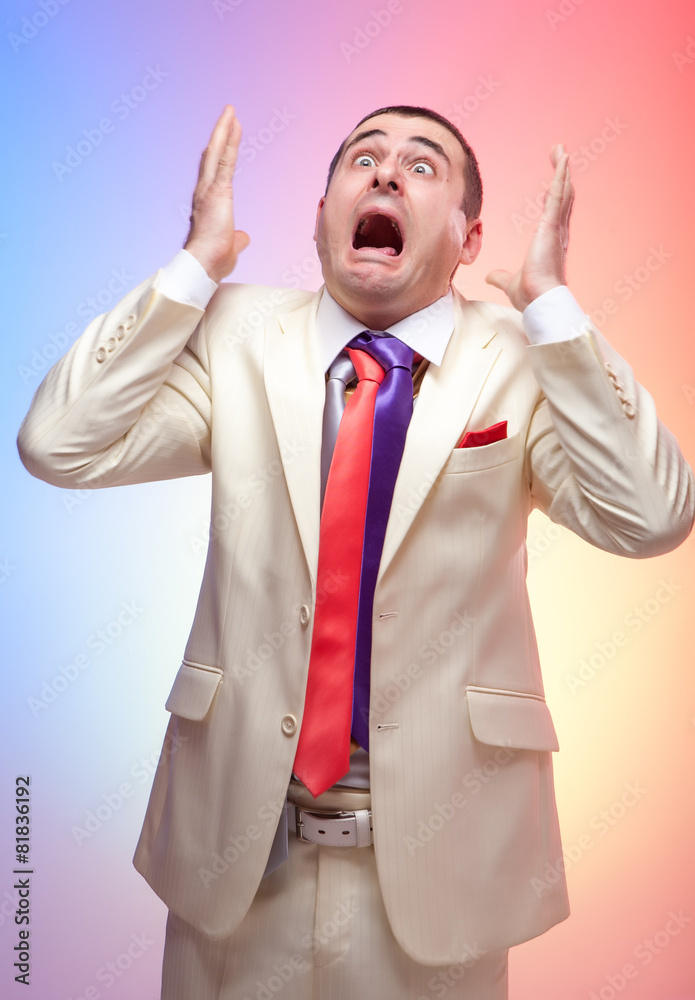 Man in white suit with three colored ties. Vivid emotions. Crazy Man in white suit with three colored ties. Vivid emotions. Crazy