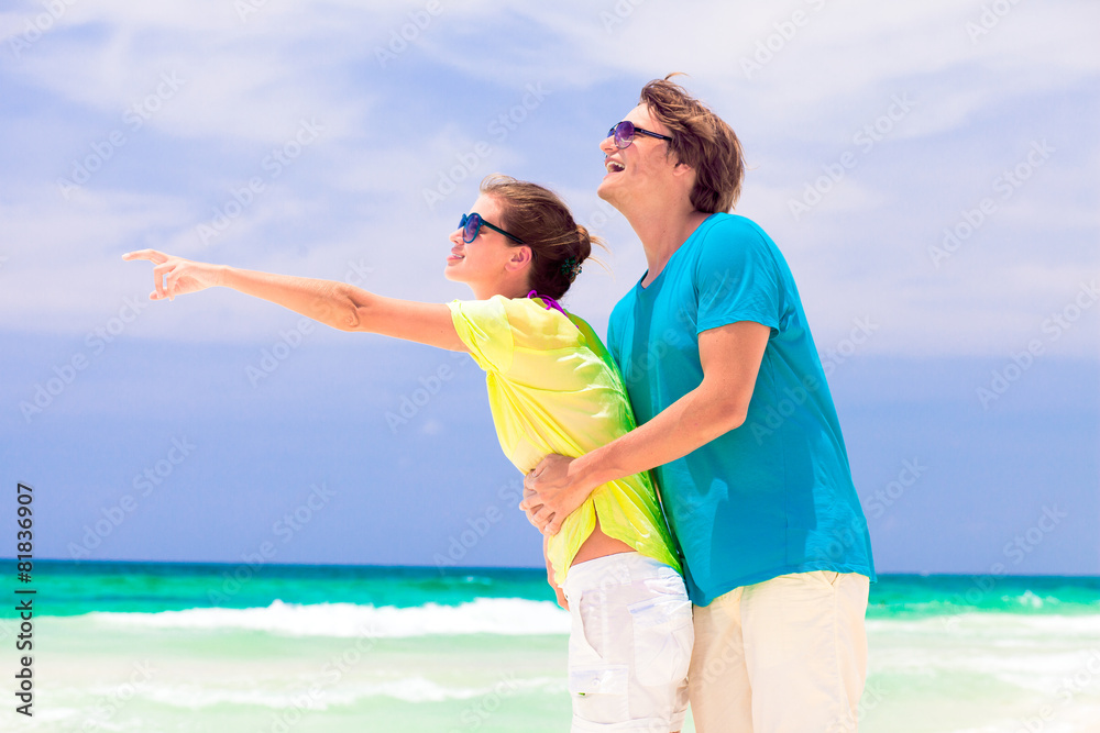 back view of happy couple in sunglasses on the beach back view of happy couple in sunglasses on the beach