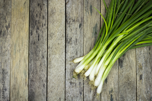onion welsh on wood plank  vegetable background