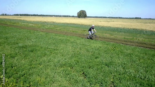 Wallpaper Mural Man cycling on a rural road. Aerial view. Torontodigital.ca