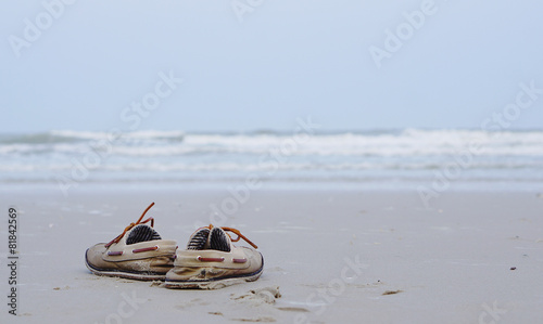 Working shoes on the beach with ocean background