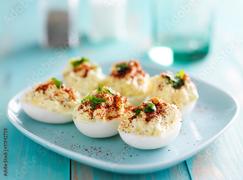 deviled eggs with paprika and green onion garnish