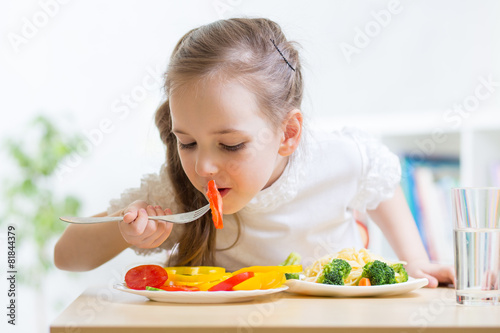 child eating healthy food a...