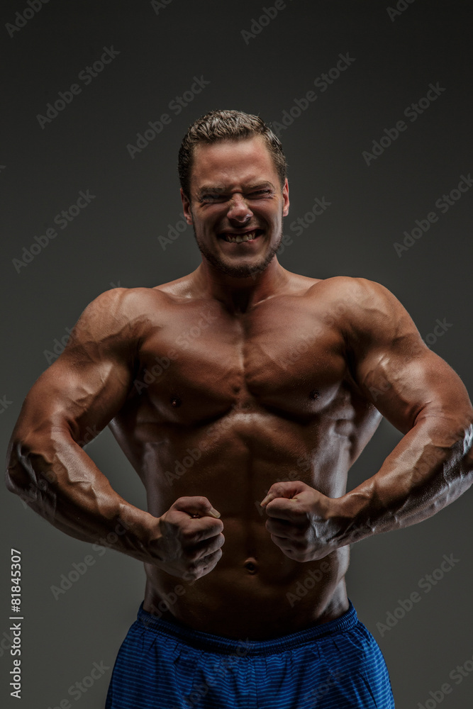 Muscular guy posing in studio