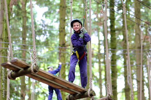 Happy kids climbing in adventure park