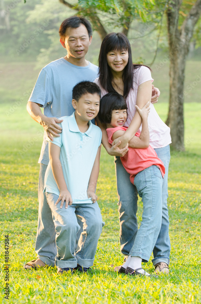 Asian Family Enjoying Walk In Summer Countryside Asian Family Enjoying Walk In Summer Countryside