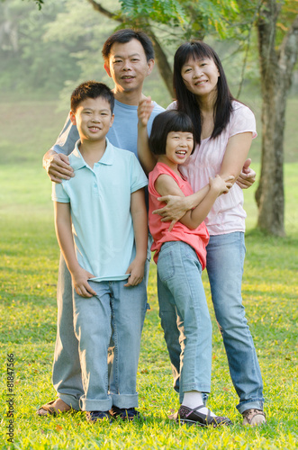 Asian Family Enjoying Walk In Summer Countryside