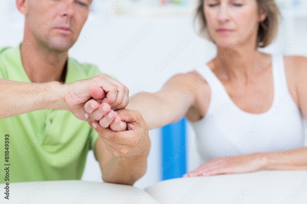 Fototapeta premium Doctor examining his patients hand