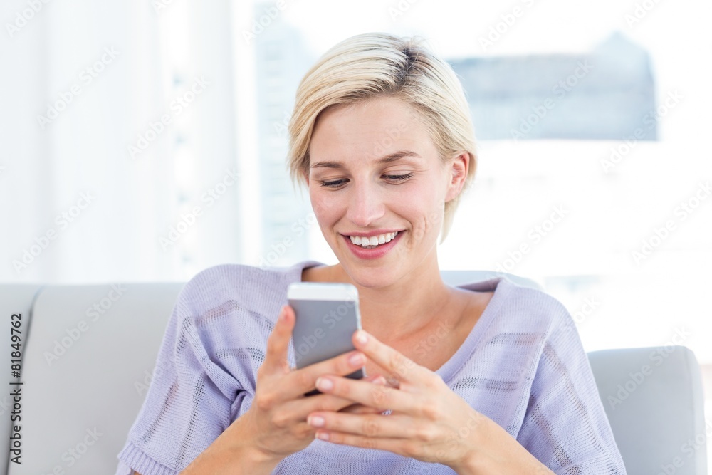 Pretty blonde woman texting with her mobile phone Pretty blonde woman texting with her mobile phone