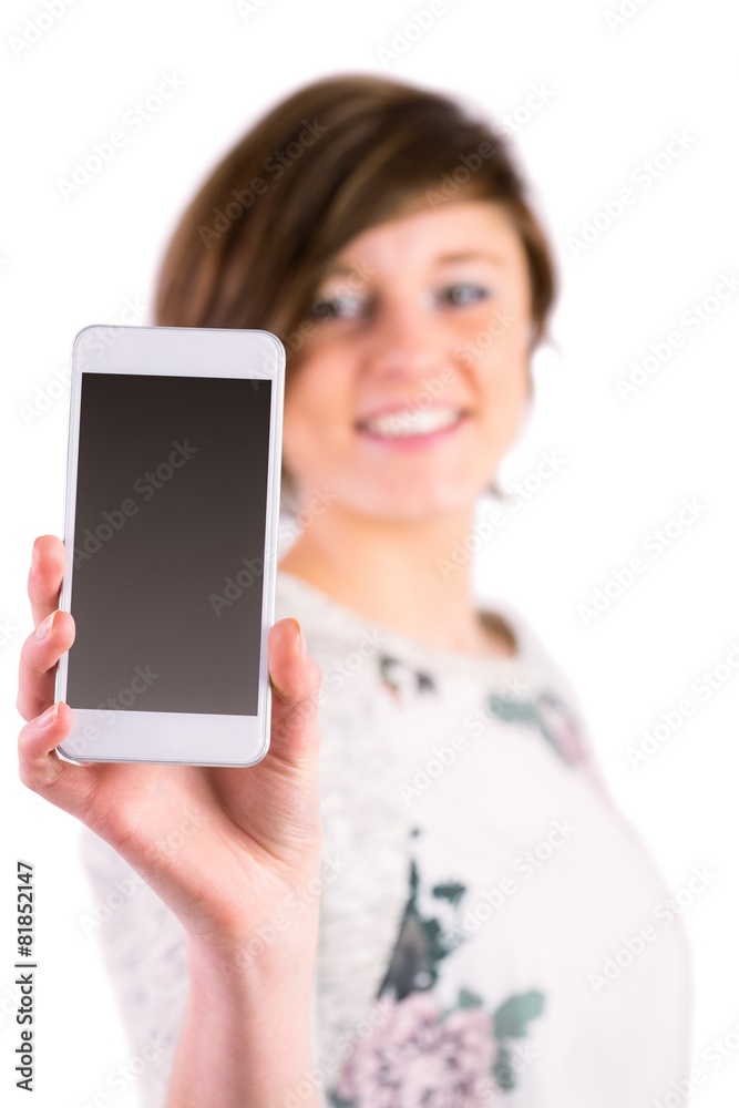 Pretty brunette holding her smartphone and looking at camera