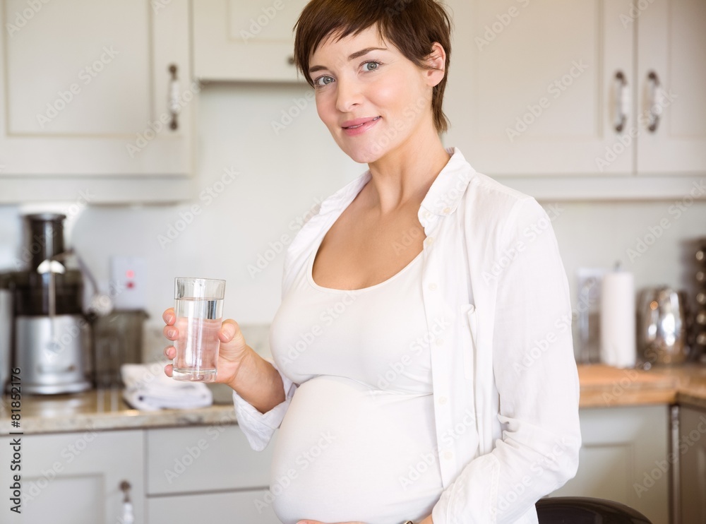 Pregnant woman having a glass of water