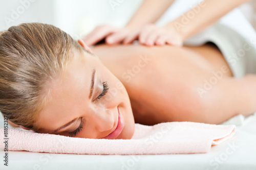 Young woman having back massage on spa treatment