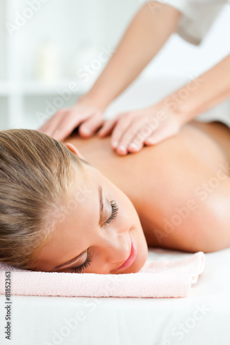 Young woman having back massage on spa treatment