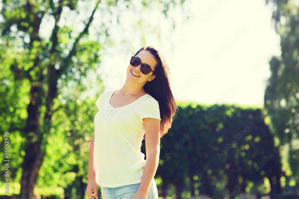 smiling young woman with sunglasses in park smiling young woman with sunglasses in park