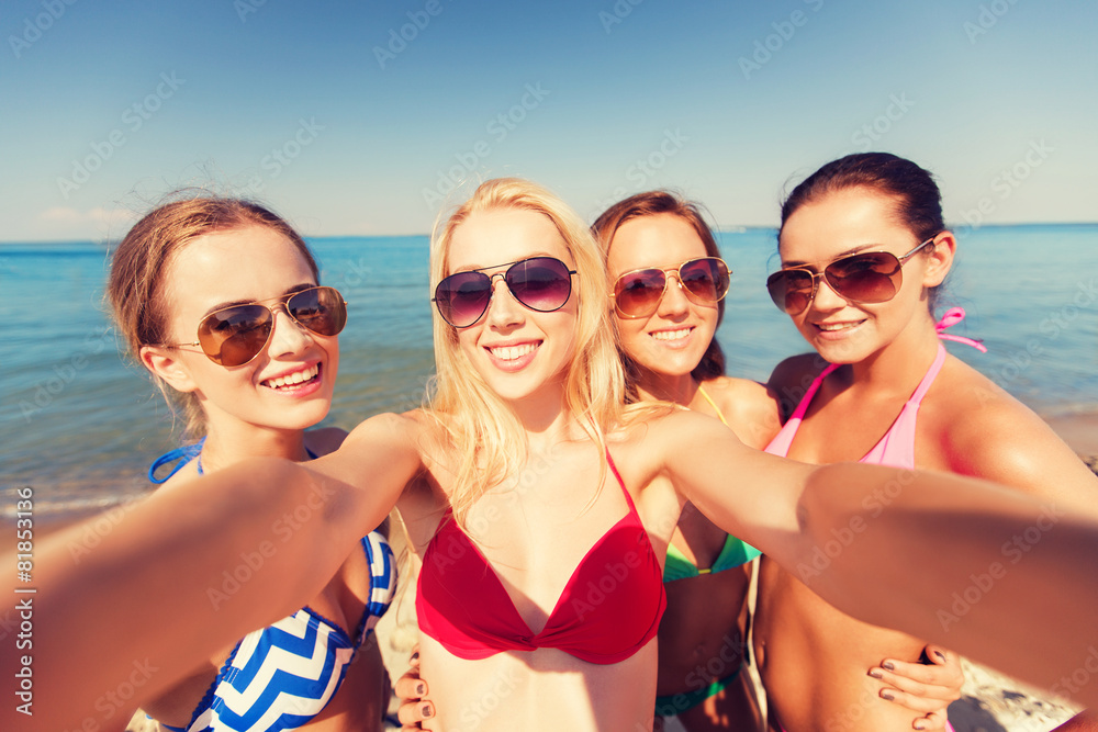 group of young smiling women making selfie
