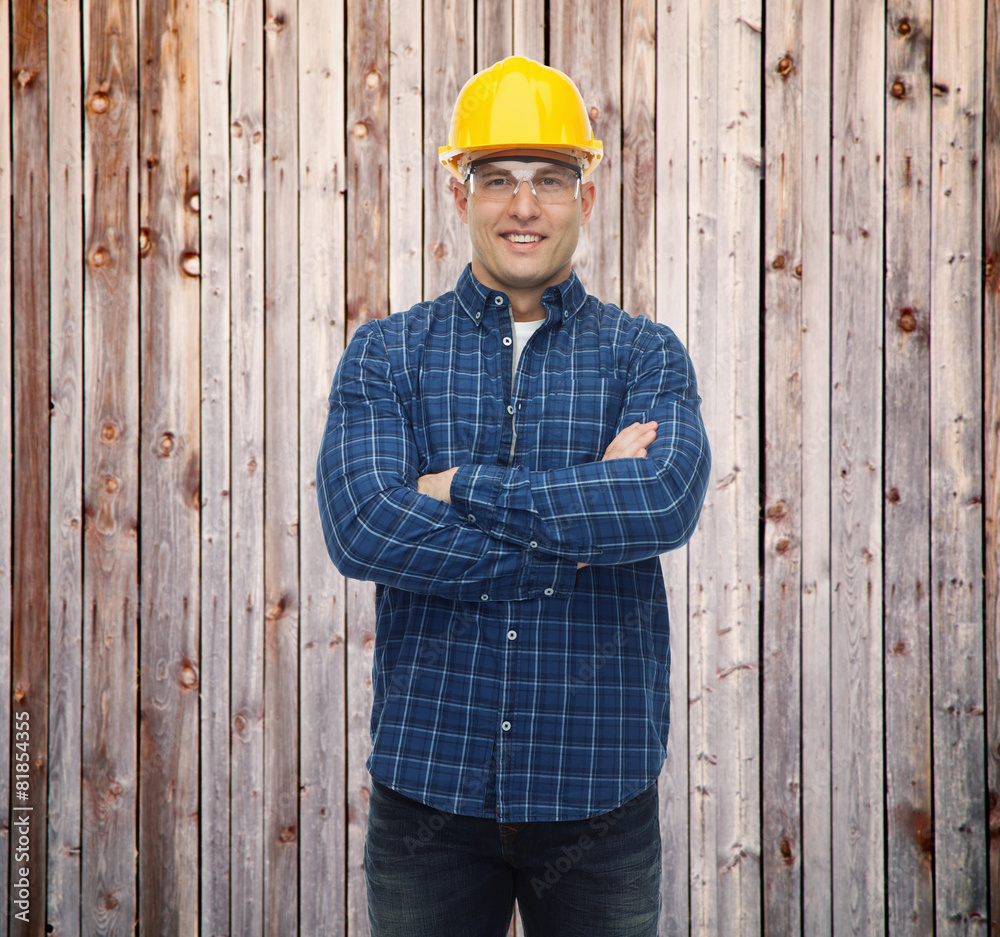 smiling male builder or manual worker in helmet smiling male builder or manual worker in helmet