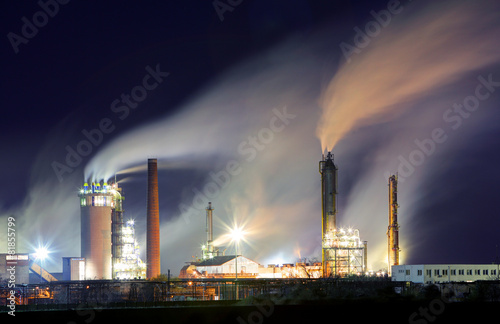 Oil refinery with vapor - petrochemical industry at night