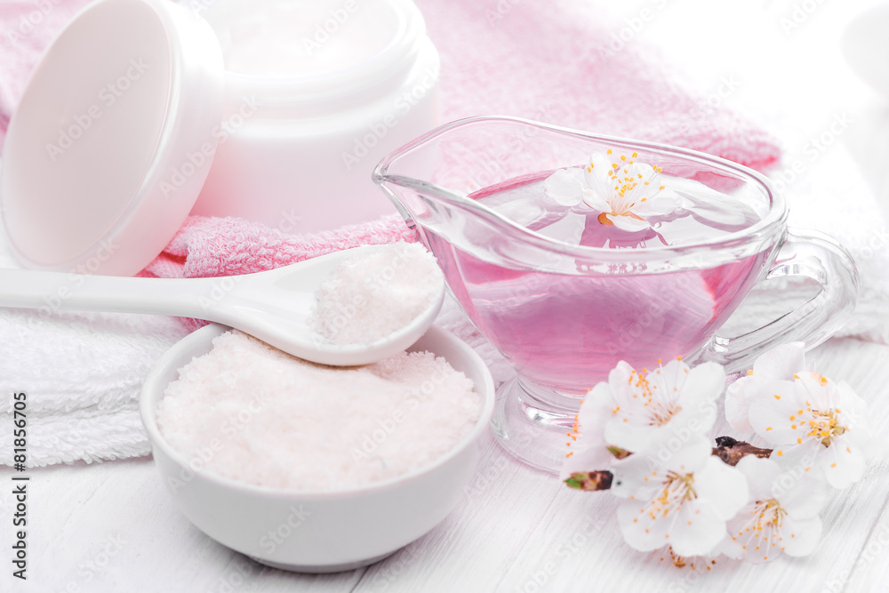still life of sea salt and essential oils and apricot flowers