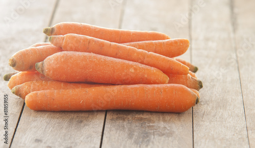 Carrot on a wooden table on wooden background