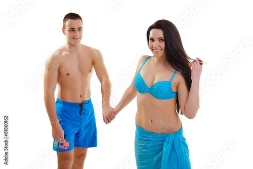 Loving couple in swimwear isolated on white background posing an