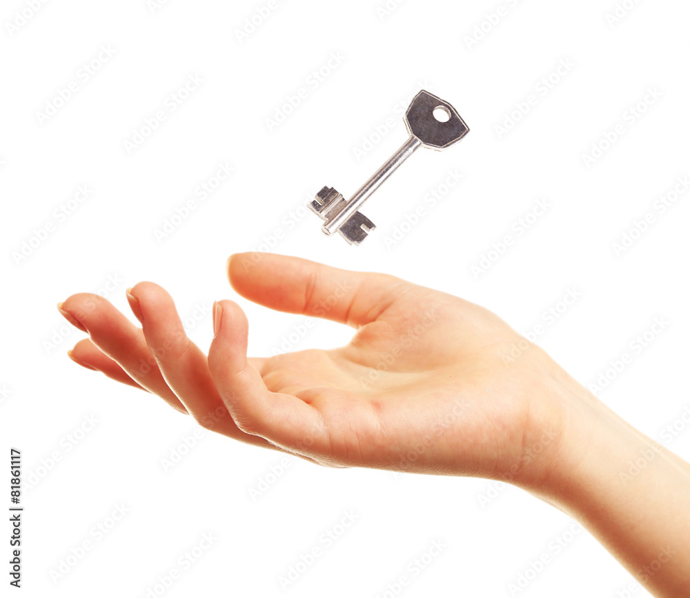 Female hand with key isolated on white Female hand with key isolated on white