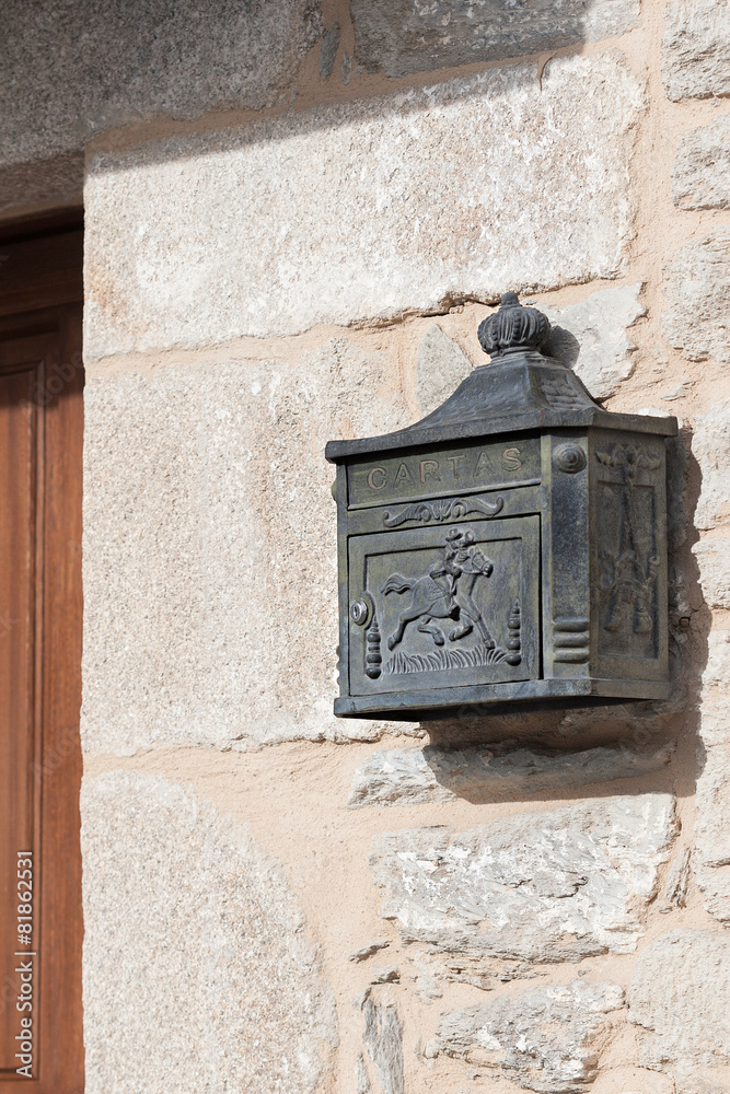 Rustic iron mailbox on a stone wall