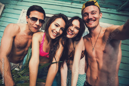 Multiracial fiends make fun selfie at beach house on vacation