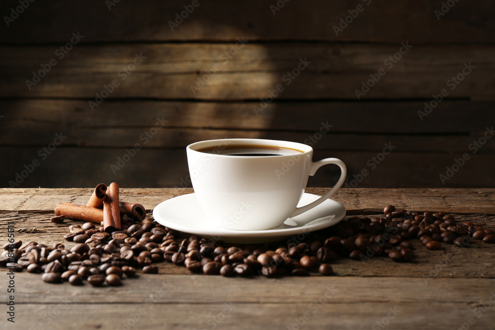Cup of coffee with grains and cinnamon sticks Cup of coffee with grains and cinnamon sticks